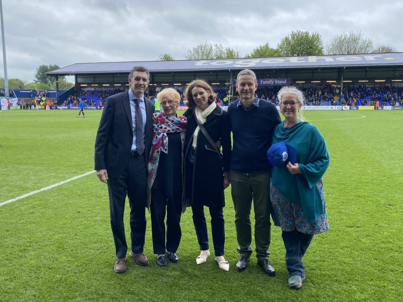 A photo of César Rodriguez Zabala, Jan Bergara, Hannah Stewart, Simon Bergara and Ellen Bergara (Byrom) on the pitch at Edgeley Park.