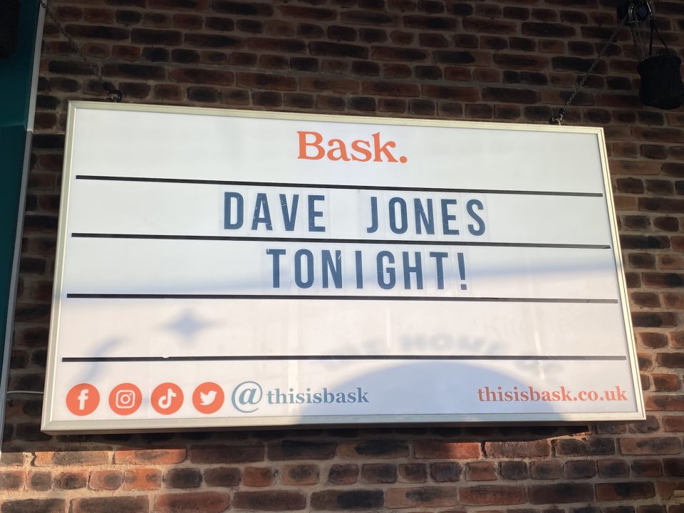 A photograph of a sign at Bask advertising the Dave Jones Tonight! event.