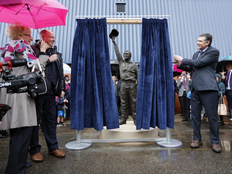 A photo of Uruguayan Ambassador, Mr César Rodriguez Zabala, Jan Bergara and Steve Bellis unveiling the statue of Danny Bergara outside Edgeley Park, Stockport.